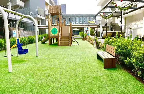 Outdoor preschool playground with swings and slide in Novena Singapore