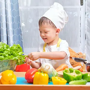 Child preparing vegetables during Fun Friday activity at Pegasus International Preschool