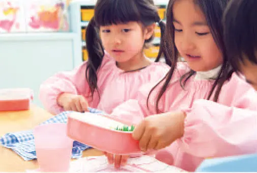 Young children eating together at a preschool lunch table